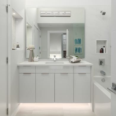 Interior image of a bathroom with the bath and white tile walls. White timeless design