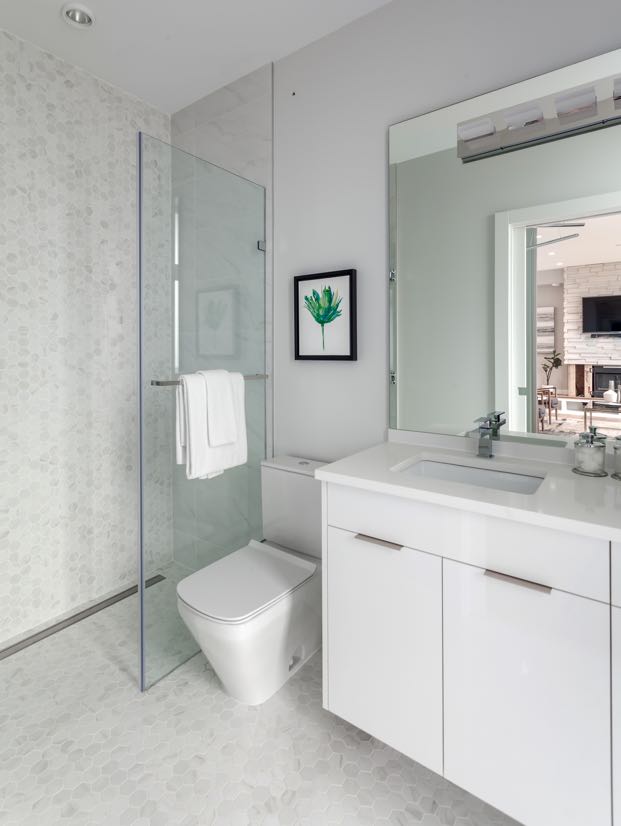 Interior image of a bathroom with the shower with timeless white tile walls