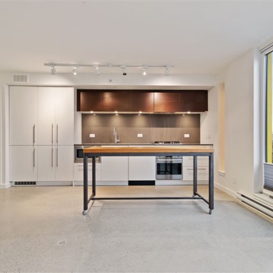 Interior image of completed residential unit showcasing efficient kitchen layout, designed by nba architects.