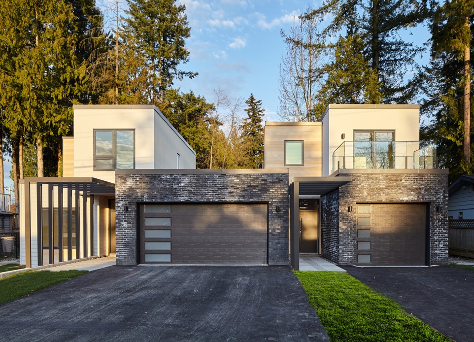a front entrance image of the two-story duplex. N B A architects designed an ultra-modern architectural design, high-performance, innovative, and sustainable home that is constructed from prefabricated SIPs.