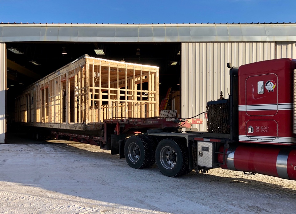 A construction image showing the installation of modular construction parts that were prepared off-site and it is in transportation to the site. Nba architects designed a staff facility building for the port workers at Deltaport.