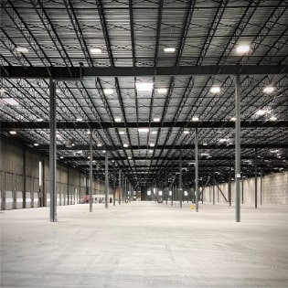 An interior image of the tenant improvement of 60,000 square foot warehouse features heavy industrial manufacturing machinery and tool shop which required a significant base building utility upgrade and independent generator.
